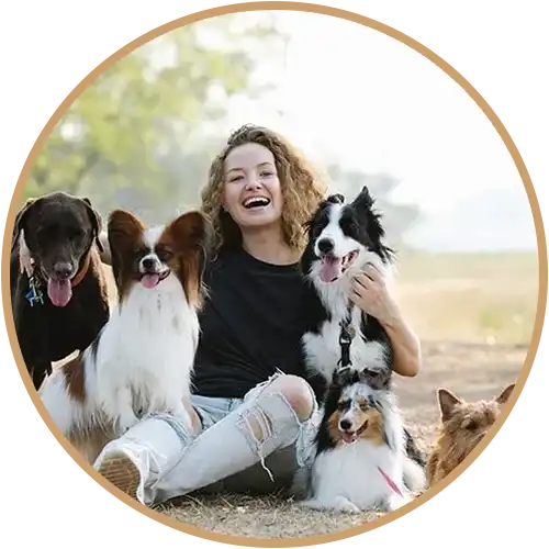 Happy woman sitting with many dogs