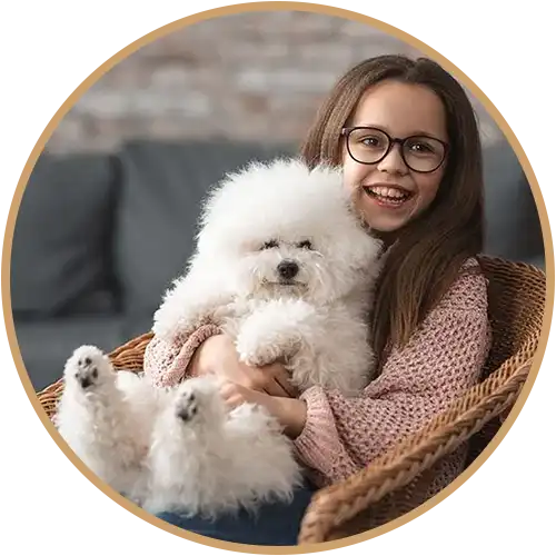 Girl holding a white dog on her lap