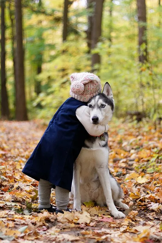 Kid hugging a husky dog